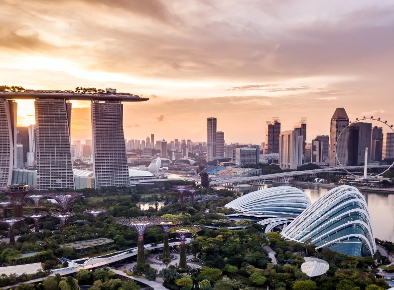 Aerial drone view of Singapore city skyline at sunset